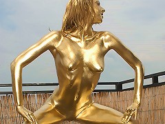 Nasty boytoy in golden bodypaint poses all naked showing you how dangerous she can be!
