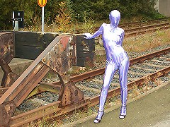 Hot Trinity exposes her lustful body in silver spandex suit in a bus station!