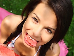 Sweet teen Kiki eating watermelon and touching herself in the garden