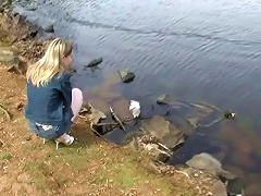 Cute blonde teen girl in mini jeans skirt Kitty Kim posing at the lake