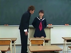 An Asian girl in a schoolgirls uniform is sitting in a classroom when a guy comes in. She seduces him, mas