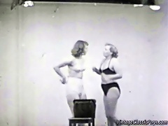 In this vintage movie we see two girls in bikini fighting with each other in a studio. They try to wrestle each ot